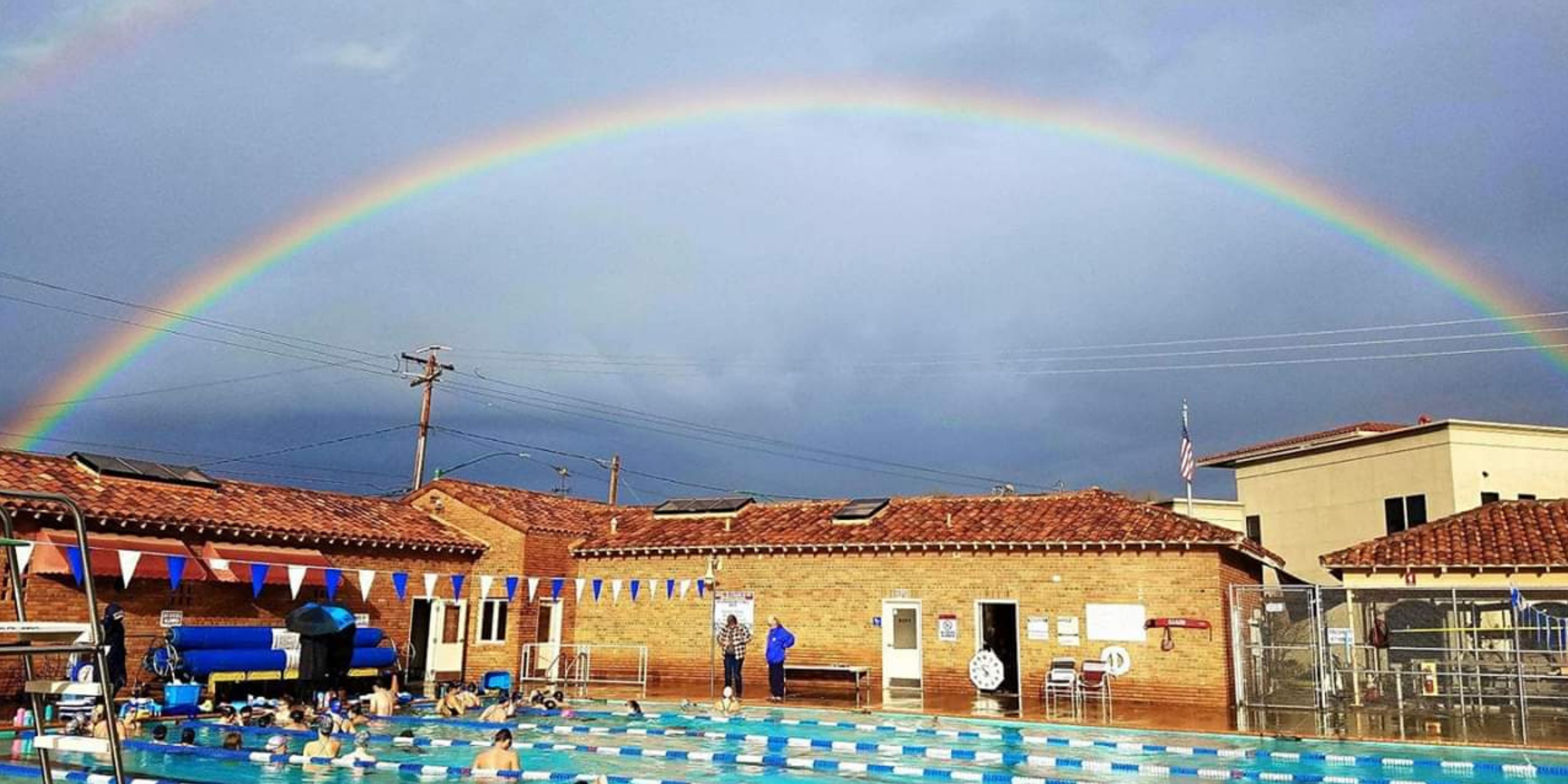 Pool with rainbow in sky