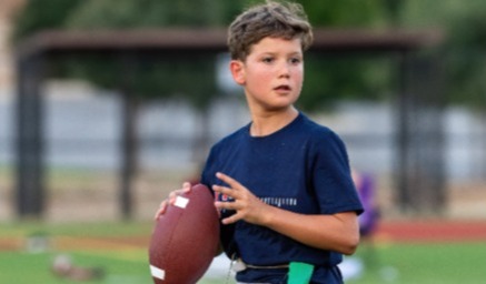 child throwing football