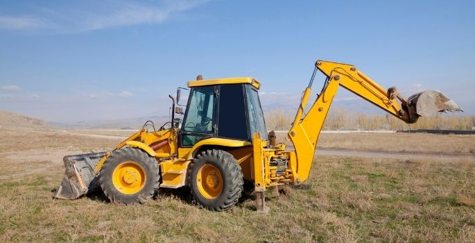 back hoe on road