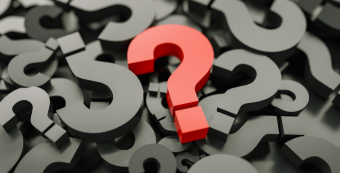 Red question mark in sea of gray question marks.