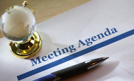 meeting agenda on a paper on top of a desk