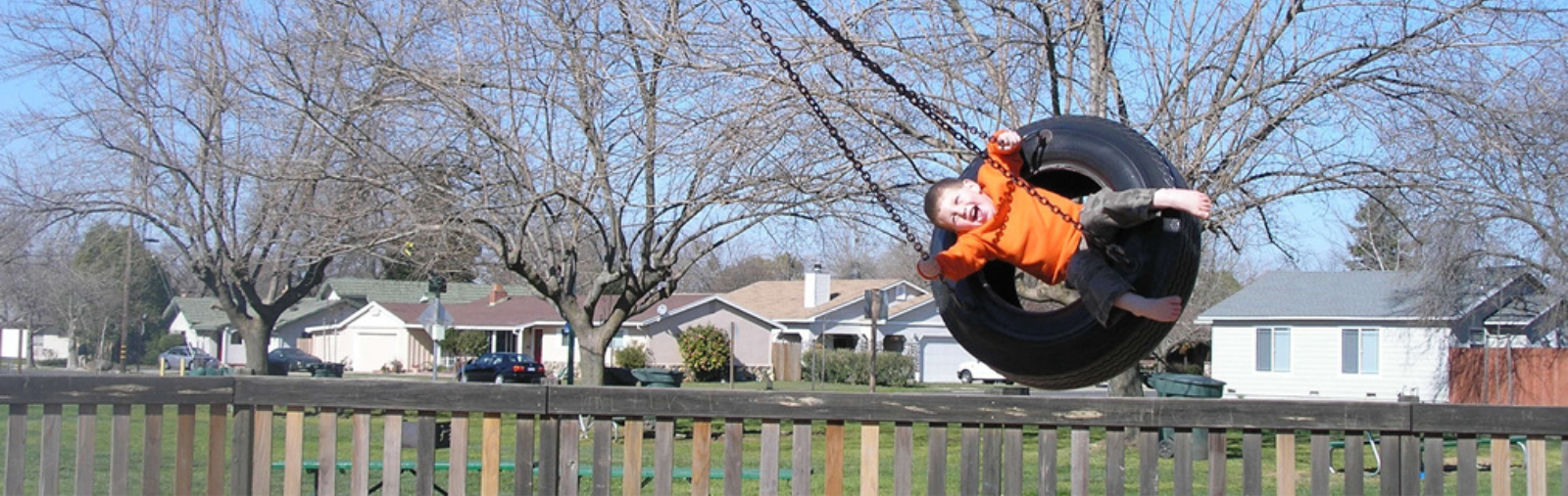 Boy on tire swing.