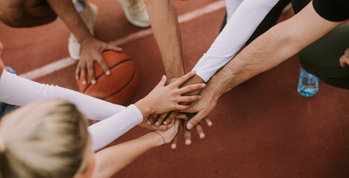 all hands in on basketball court