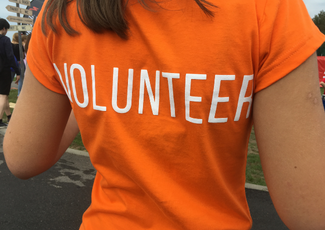 Orange shirt with volunteer written.