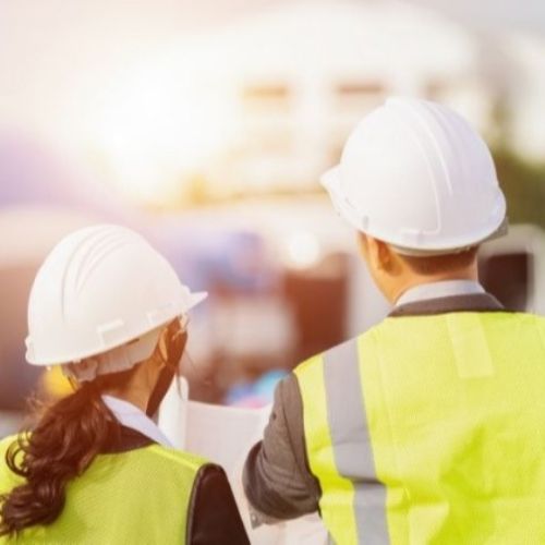 engineers in hard hats and safety vests at jobsite