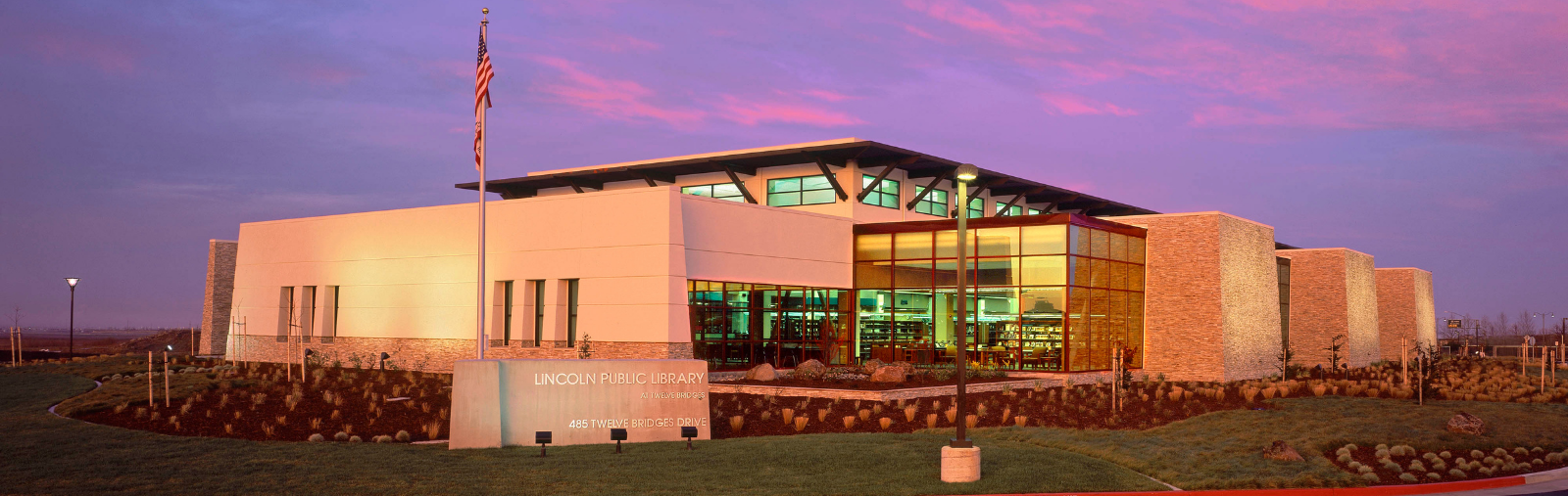 Exterior of the Twelve Bridges Library at sunset