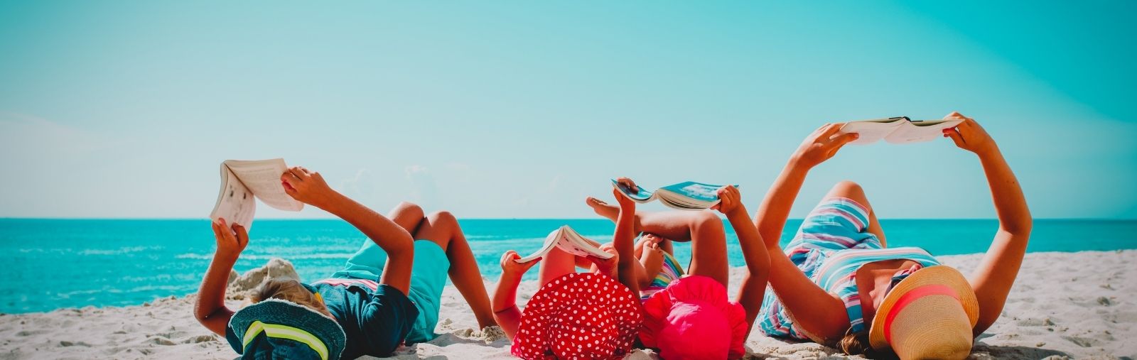 A family reading on a beach