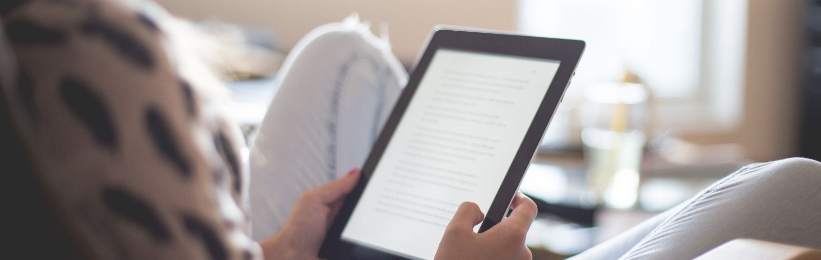 A woman reading on a tablet