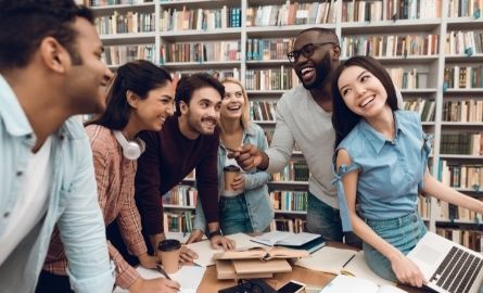 A group of people in a library, laughing