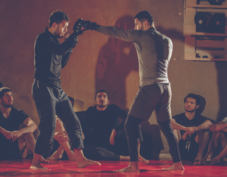 Two men sparring 