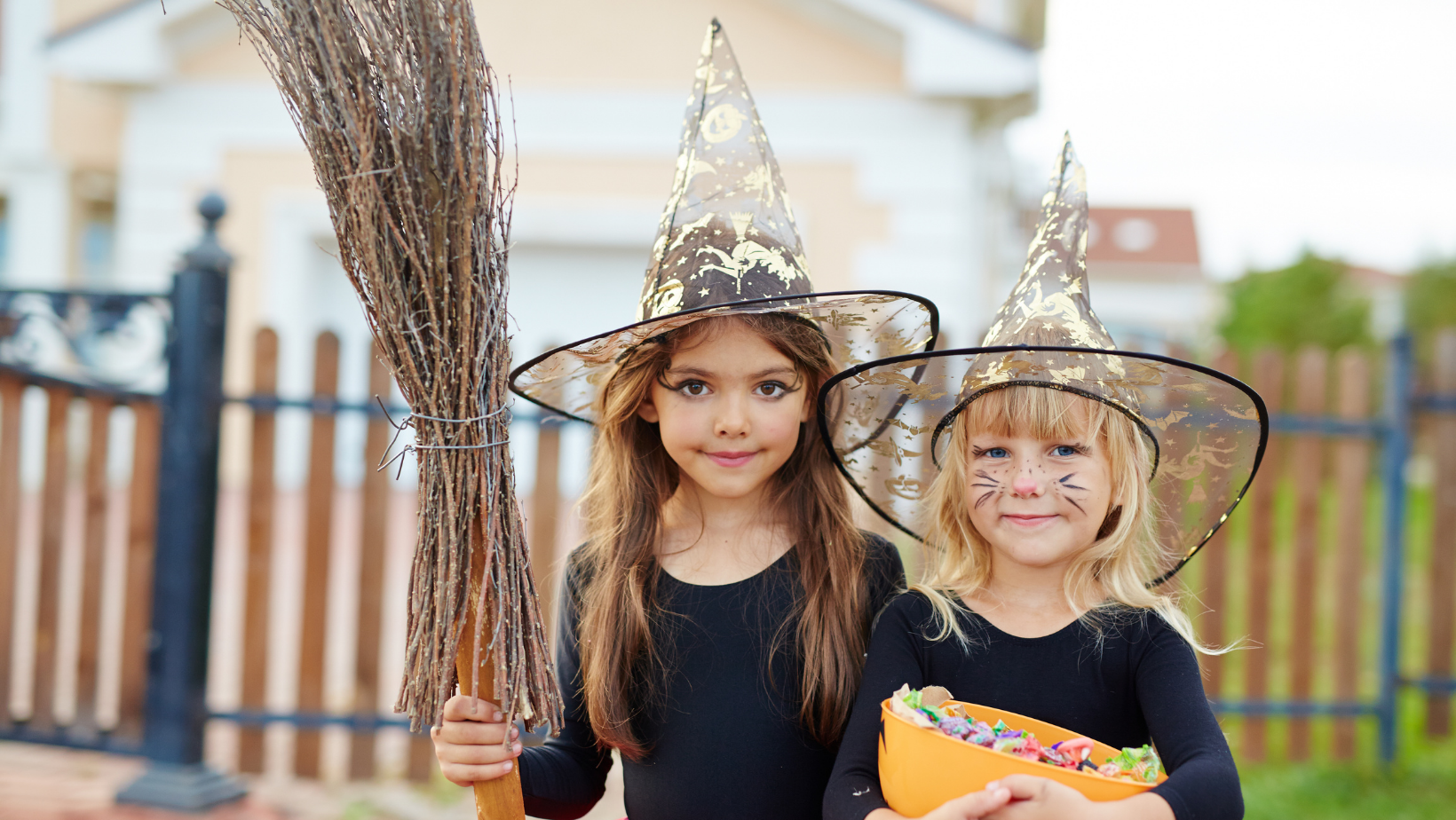 girls in Halloween costumes standing in the park