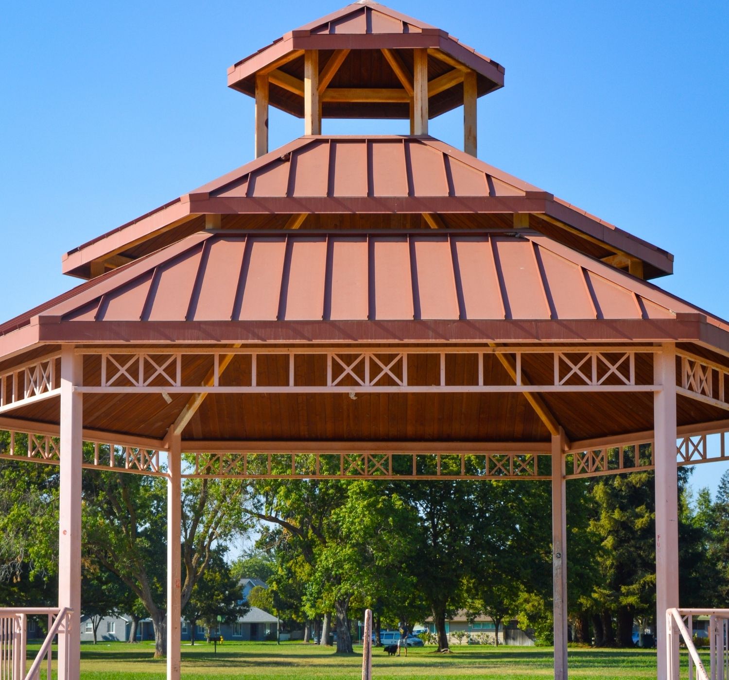 Light red and orange shade structure with green grass