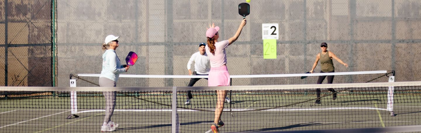 adults playing pickleball