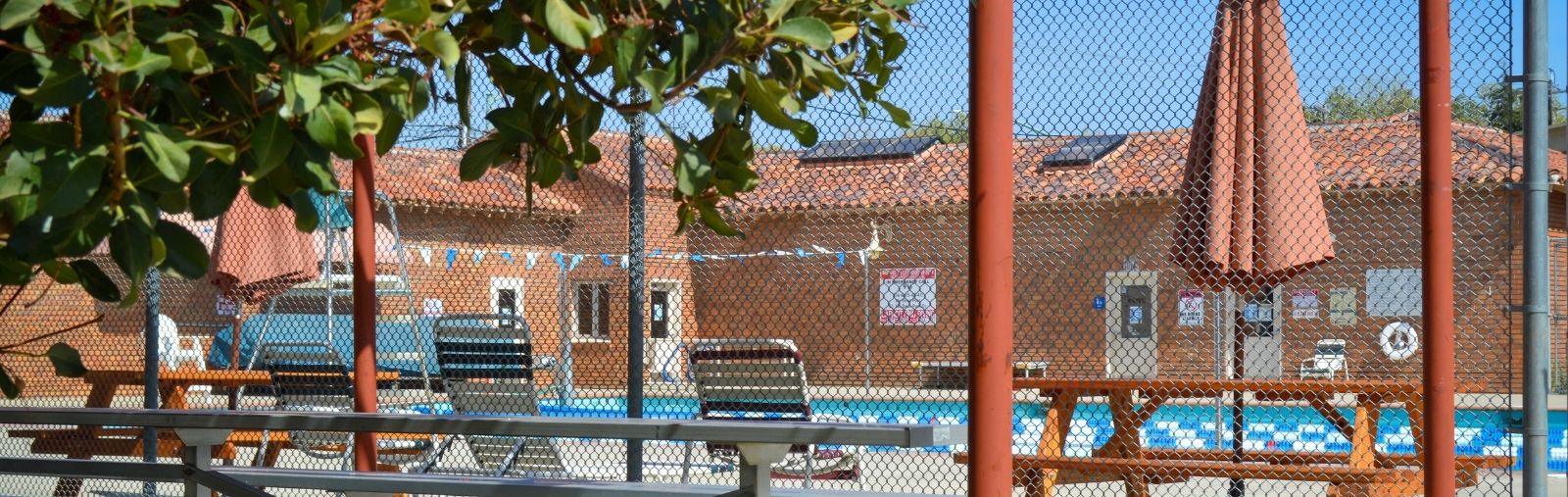 Brick building with blue pool on sunny day