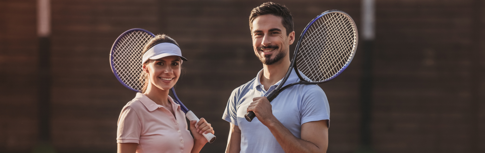 women and man holding tennis racquets