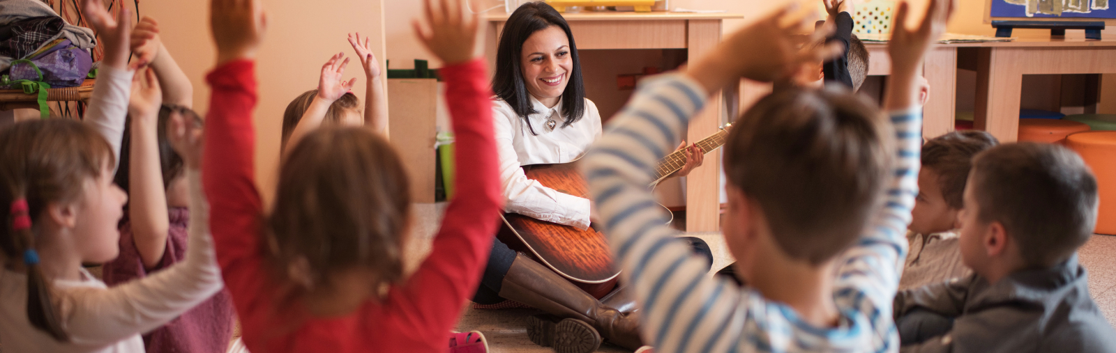 music teacher sitting with children