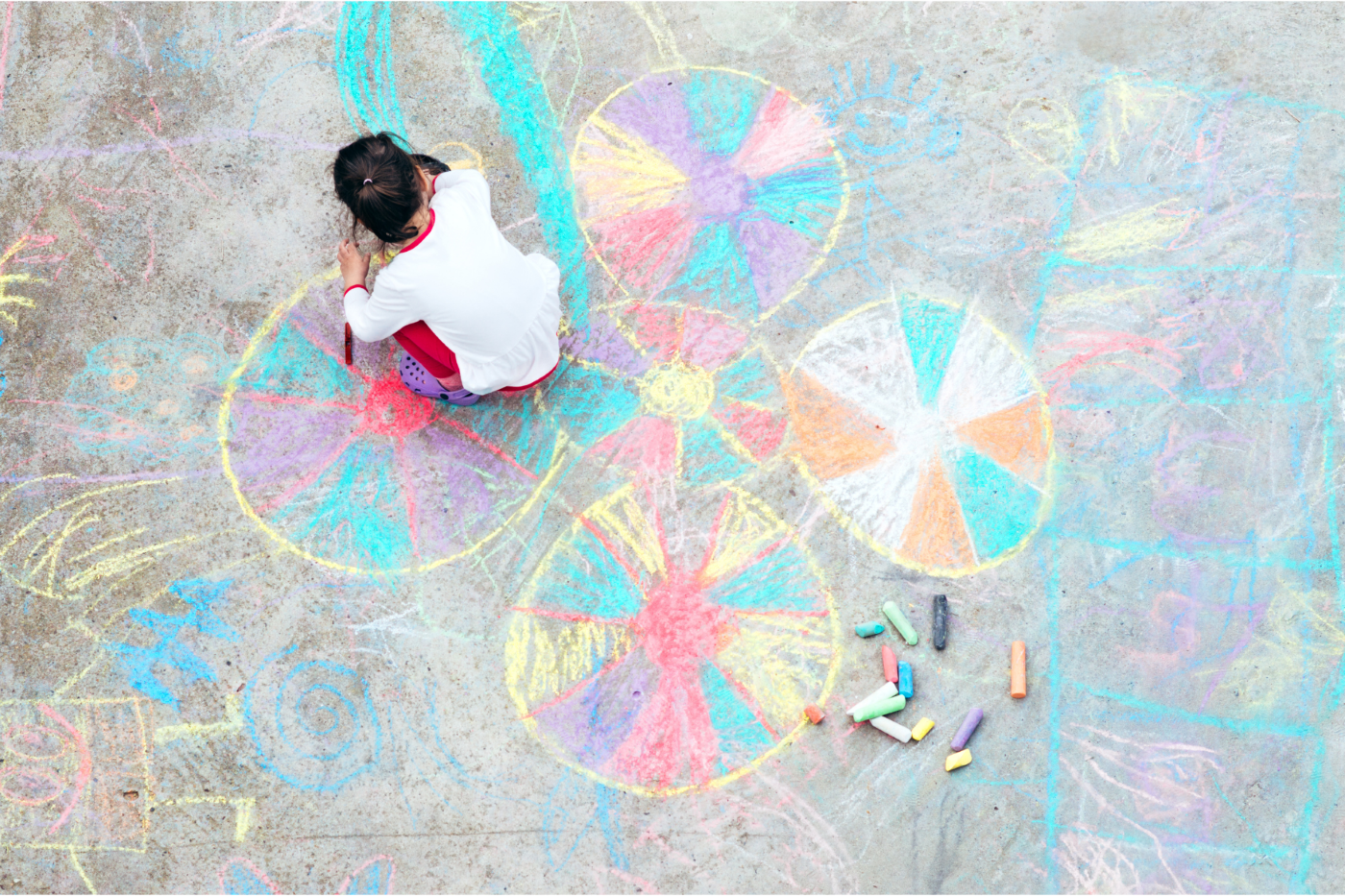 Young girl playing with chalk
