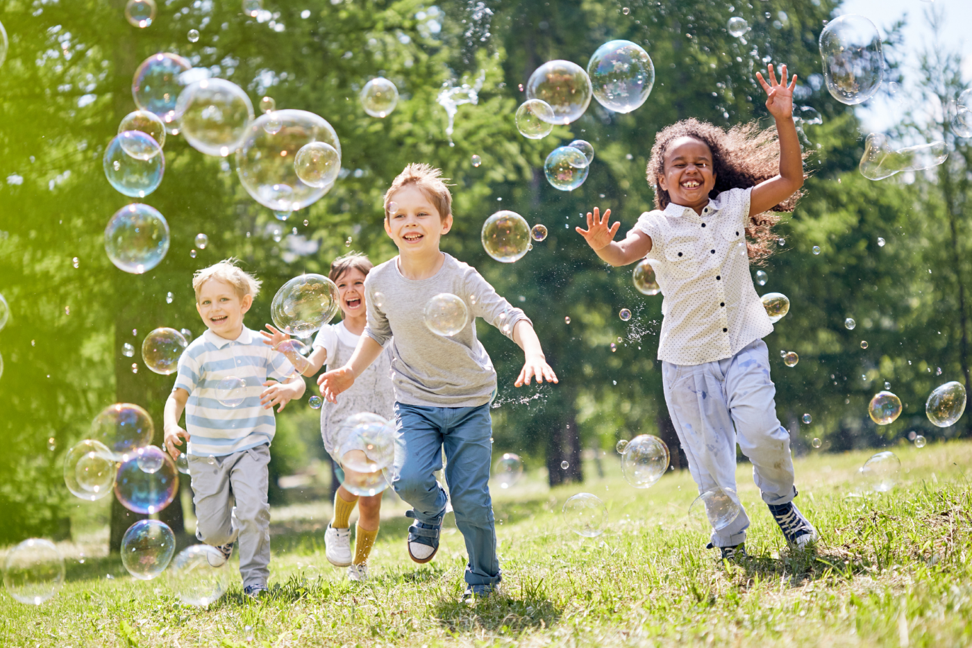 Young kids chasing bubbles