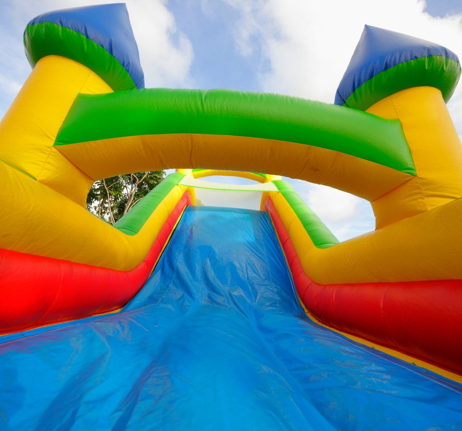 Blue, yellow, green and red castle bounce house