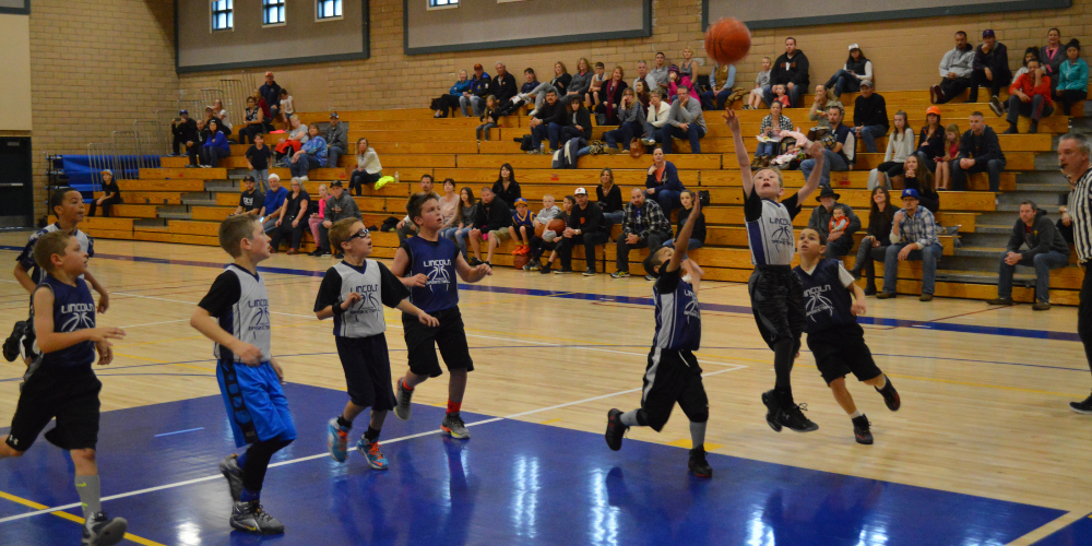 Young boys playing basketball in the gym 