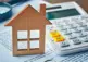 alt="Wood house and calculator"