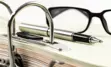 alt="Report with glasses and pen."