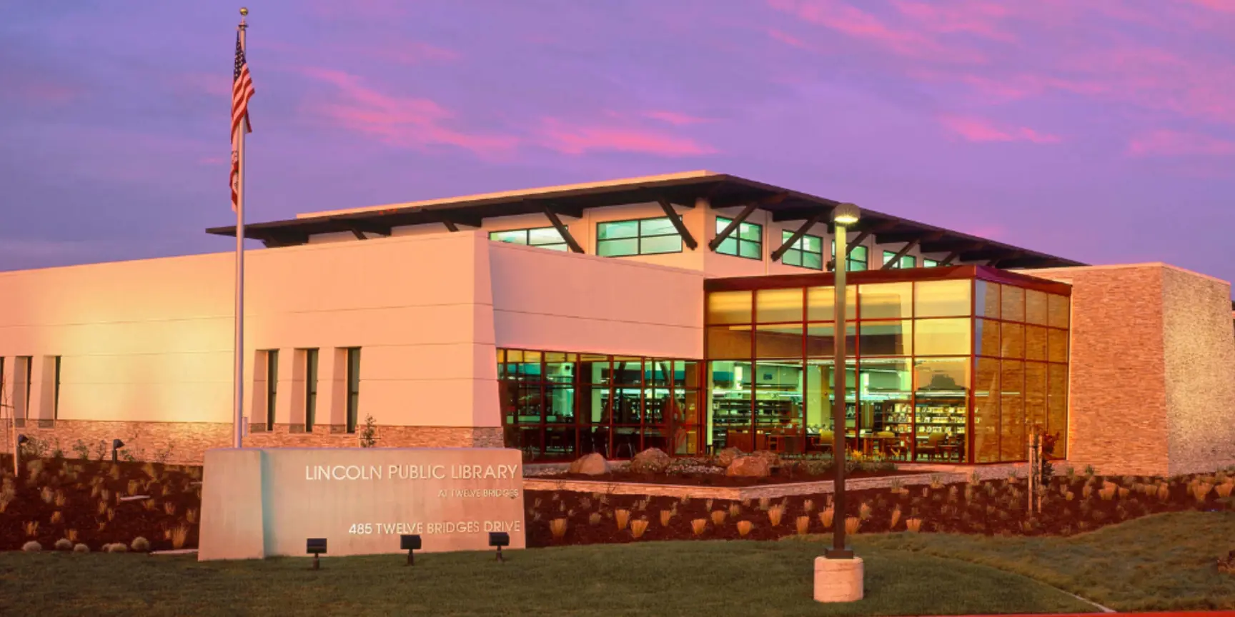 "White building with sunset behind"